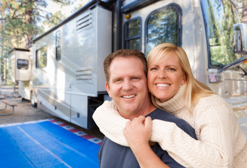 couple in front of RV