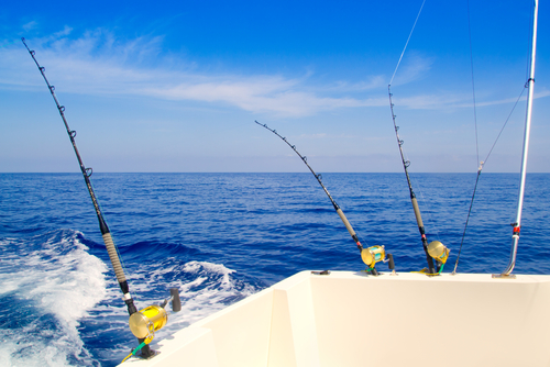 Fishing poles on boat in ocean