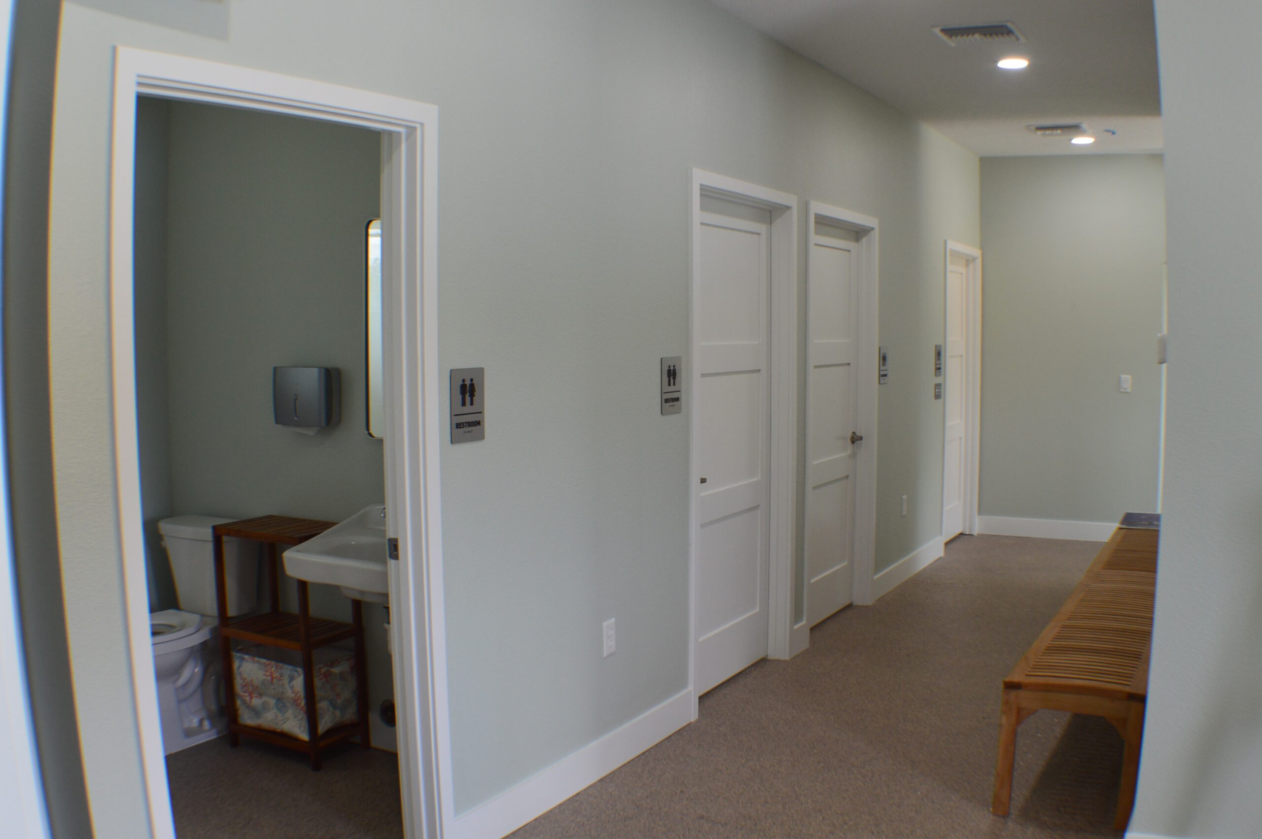 row of bathrooms in clean hallway